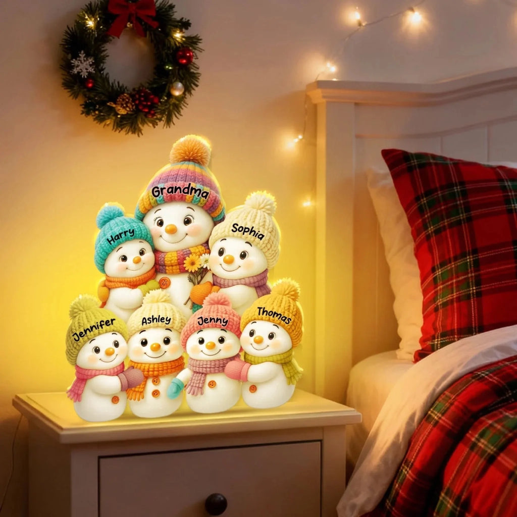 Personalized snowman light box glowing on a nightstand at night