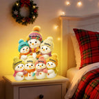 Personalized snowman light box glowing on a nightstand at night