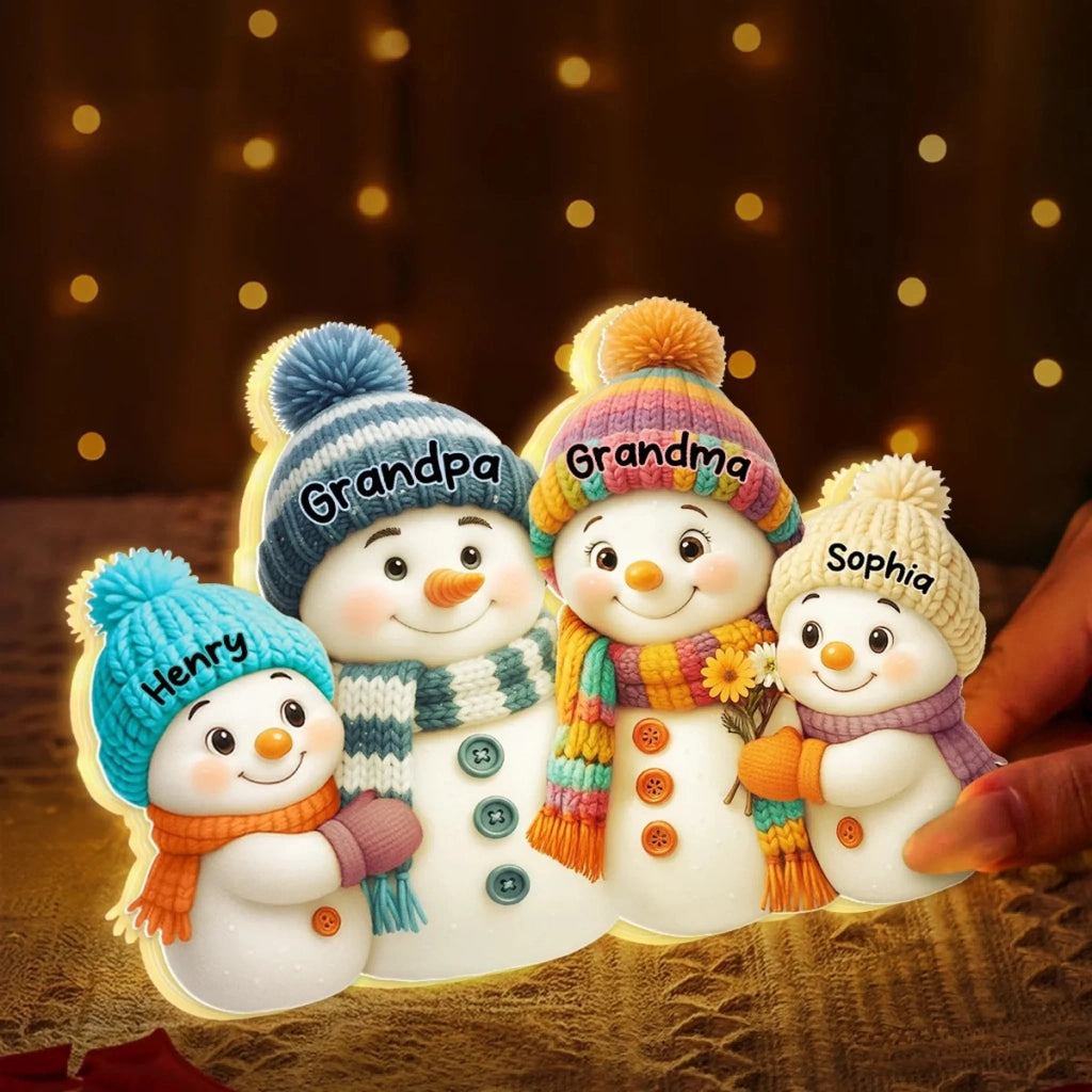 Personalized snowman light box glowing beside Christmas decorations