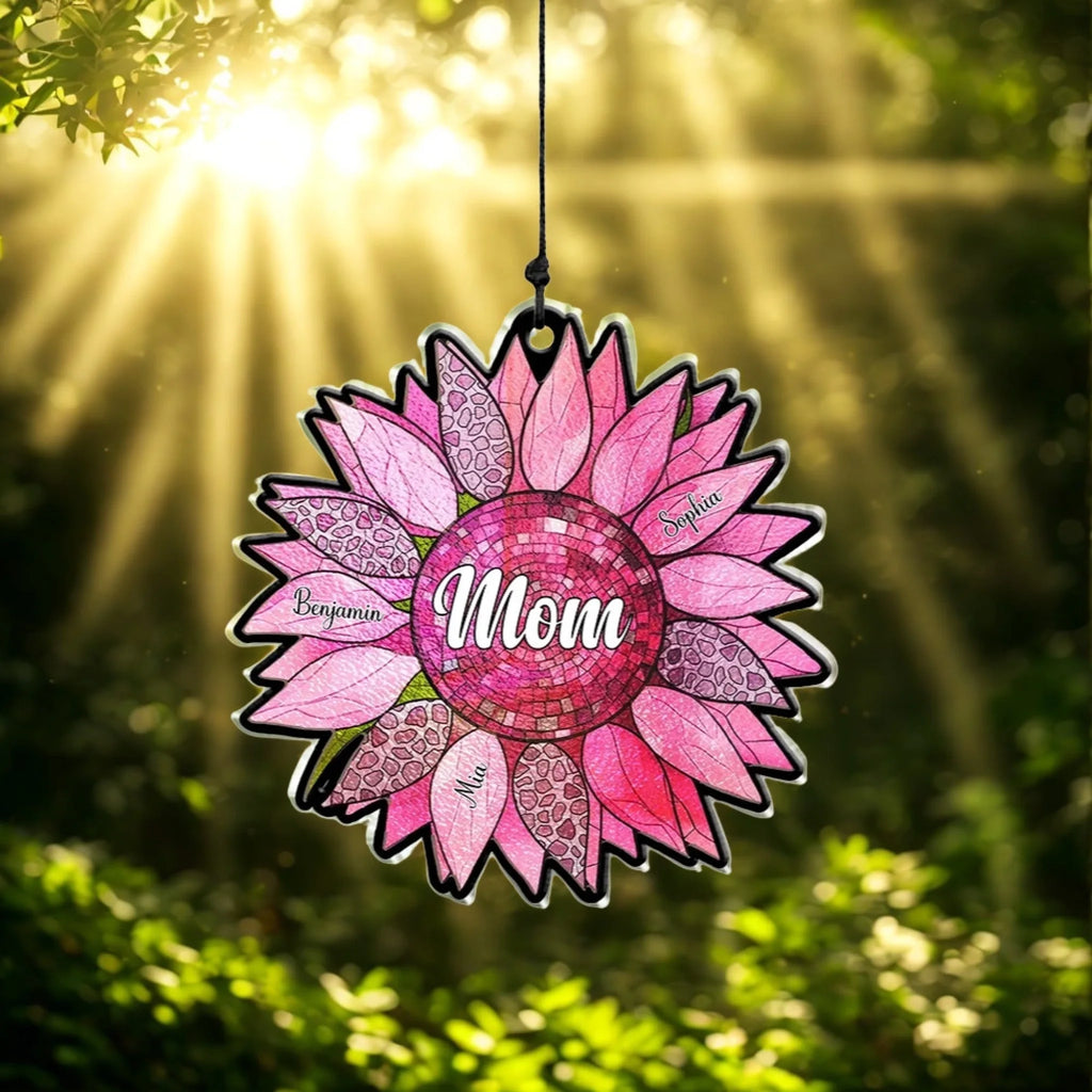 Personalized pink sunflower suncatcher with Mom at the center and three family names, backlit by sunbeams